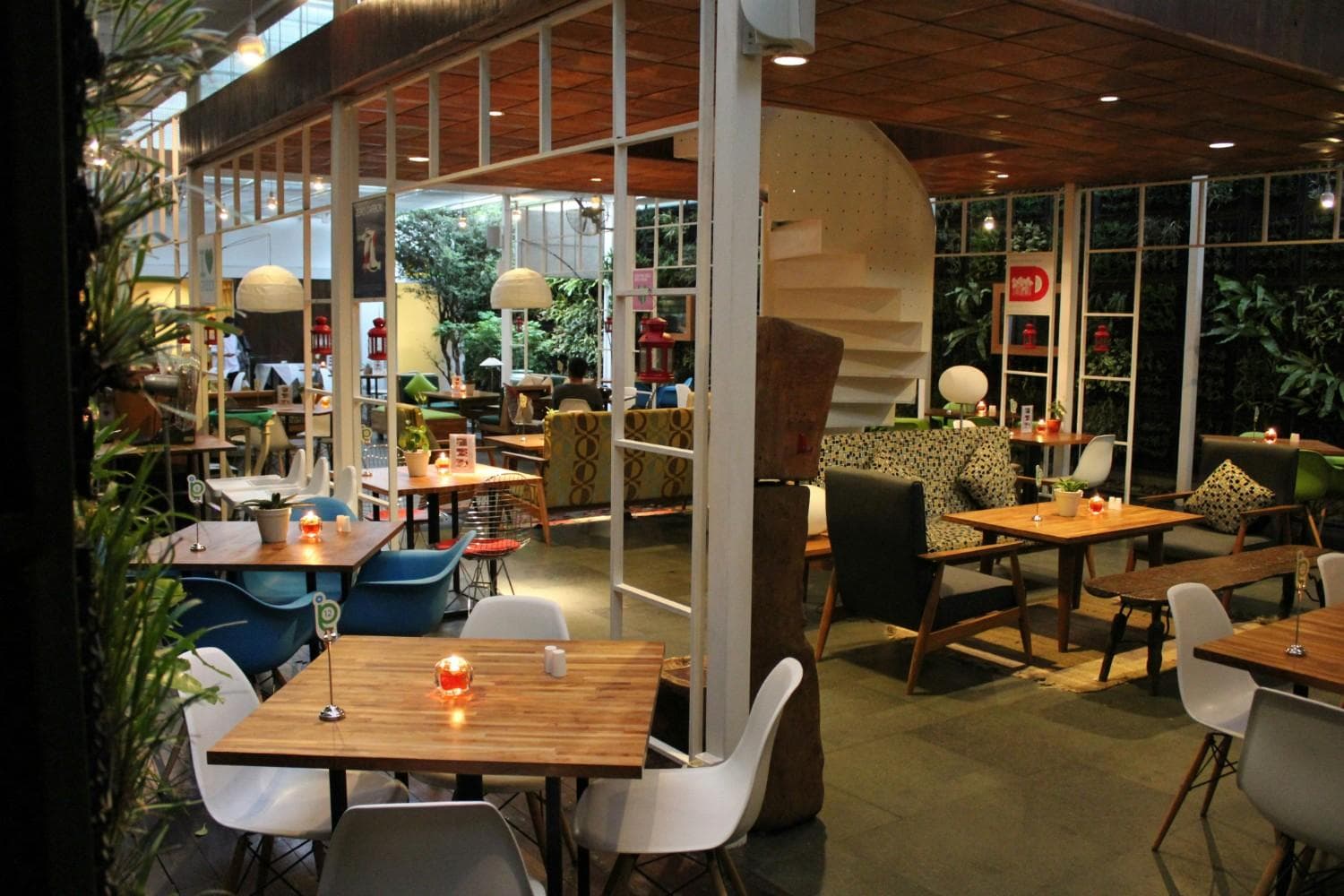 Modern restaurant interior with plants and warm lighting
